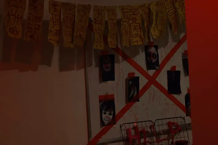 Decorated wall crossed out with red tape under a paper garland
