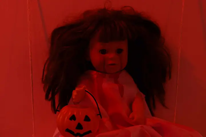 Creepy doll under red light