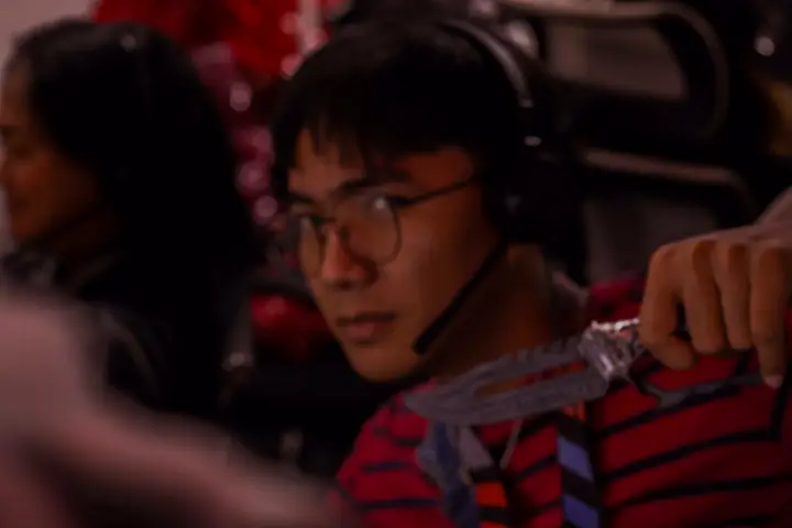 Agent in costume with a headset at his desk
