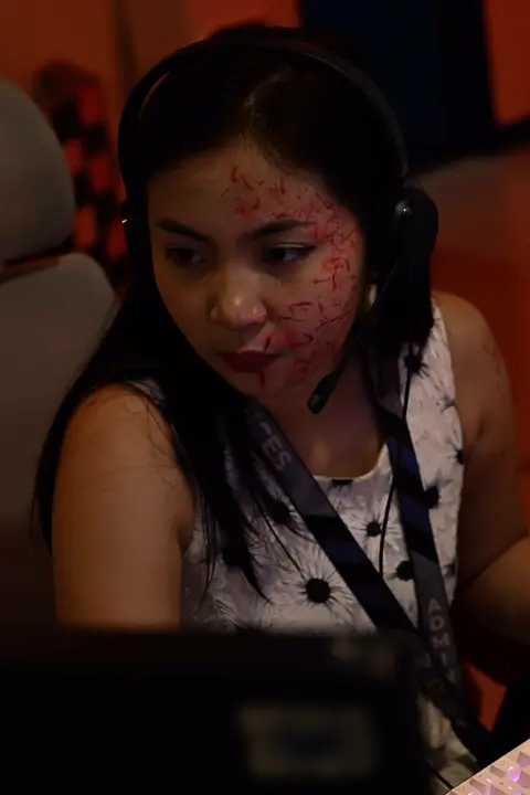 Agent in blood-spatter make-up working with a headset
