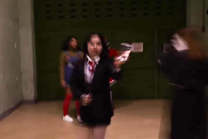 Teammates in costume rushing down a hallway